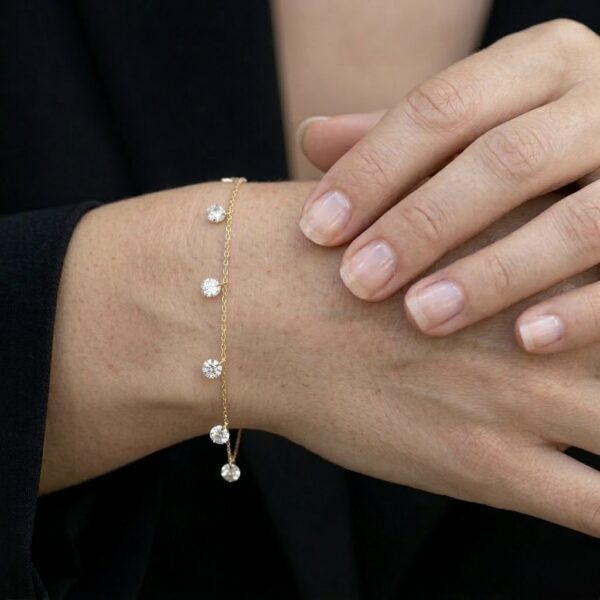 צמיד Gleam עשוי כסף 925 בציפוי זהב עם 7 זרקונים קדוחים ואורך 16+5 ס"מ על הדוגמנית